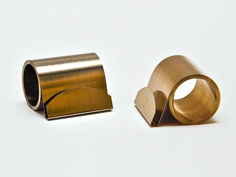 Constant Force Springs Two small constant force springs with a money clip-style end detail, showcasing their compact design and specialized attachment feature. Small but strong—constant force springs with money clip ends provide secure and efficient functionality in compact applications.