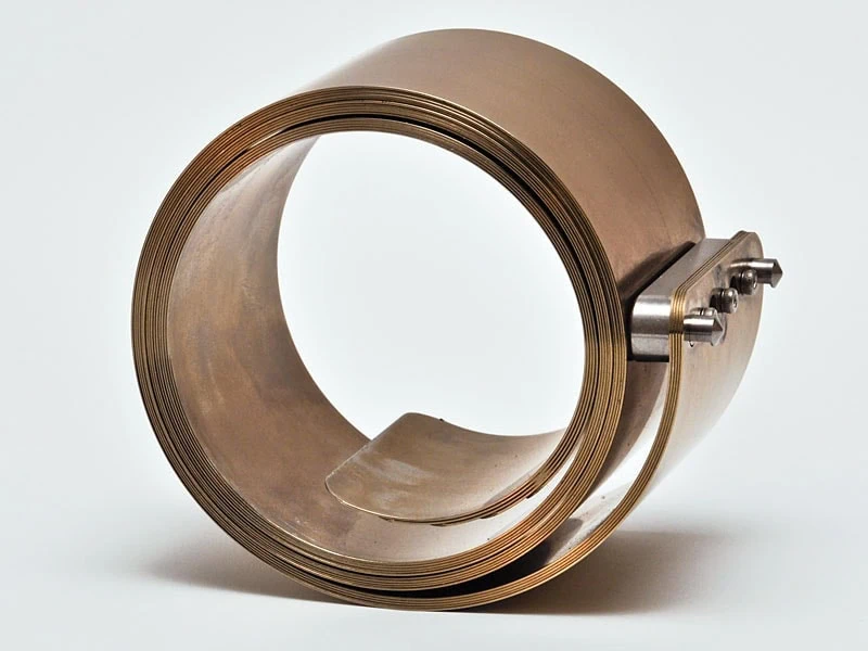 Mechanical Assemblies Mechanical Assembly of mounted spring stamping on laminated constant force springs.