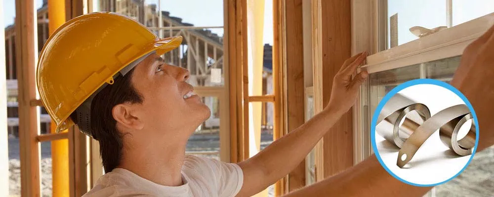 Window Springs Person installing window in house under construction, crafted with window balance products.